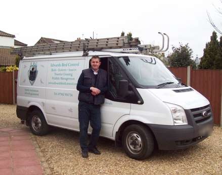 The white Edwards Bird Control van with ladders on the roof